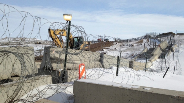 Razor wire and concrete barriers protect access to the Dakota Access pipeline drilling site. 
