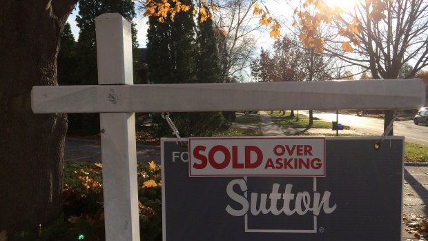 A "sold over asking" sign is shown on a real estate sign in Oakville, Ont., Thursday, Nov.17, 2016. 