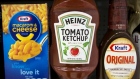 A Heinz Ketchup bottle sits between a box of Kraft macaroni & cheese and a bottle of Kraft Original