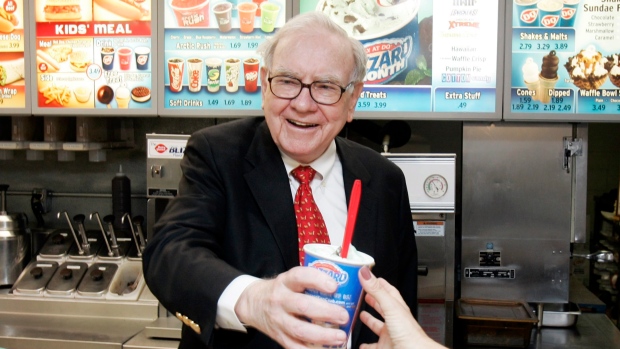 Warren Buffett hands out a Girl Scout Thin Mint Cookie Blizzard at a Dairy Queen in Omaha, Neb.