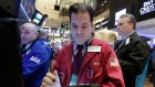 Trader Christopher Lotito, center, works on the floor of the New York Stock Exchange