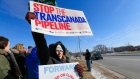 Kelly Kelly of Omaha waves signs with others opposing the Keystone XL oil pipeline during a protest