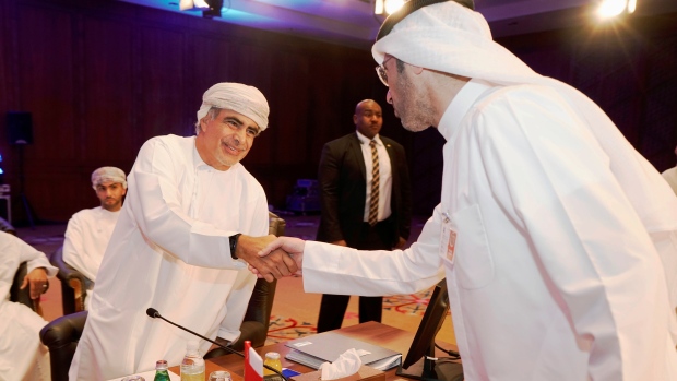 Oman Oil Minister Mohammed bin Hamad Al Rumhy and a representive of Kuwait Oil Company