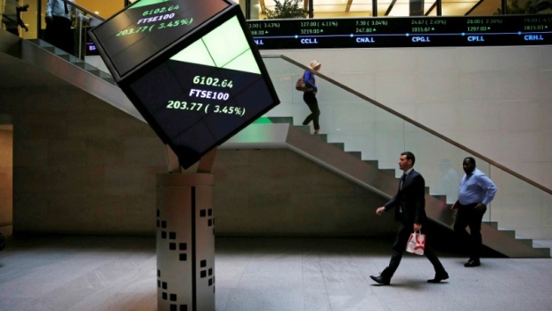 People walk through the lobby of the London Stock Exchange in London, Britain August 25, 2015. 