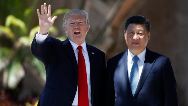 President Donald Trump and Chinese President Xi Jinping pause for photographs at Mar-a-Lago