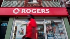 A man walks by a Rogers store in Toronto