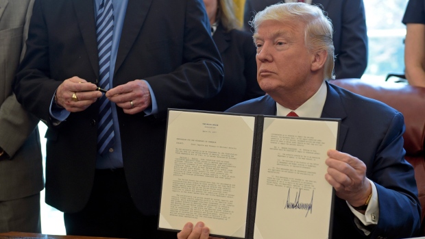 Donald Trump displays his executive order on foreign steel