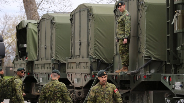 Reservists help pack military vehicles with boats and fuel at CFB Kingston Kingston, Ont.