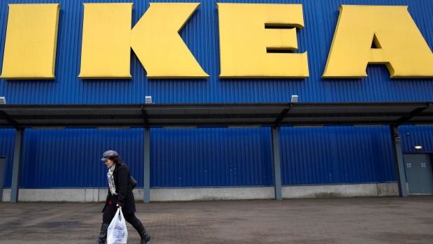 A shopper walks past a sign outside an IKEA store in Wembley, north London, Britain