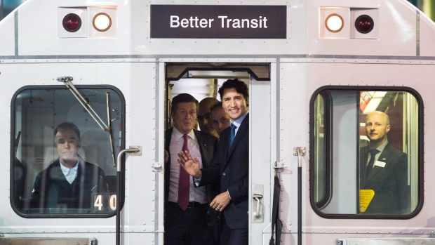 Prime Minister Justin Trudeau, right, and Toronto Mayor John Tory ride on a TTC subway