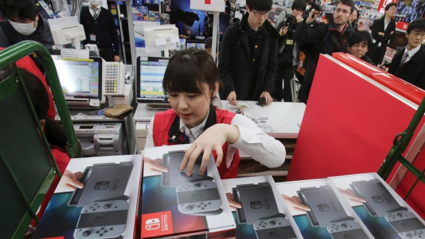 Employee of the electronics retailer Bic Camera sells Nintendo's newest console "Switch" 