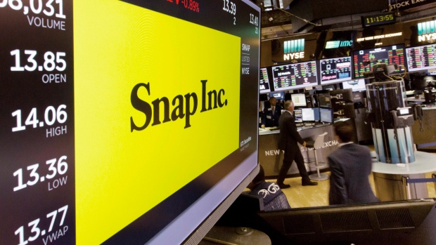 In this Monday, Aug. 7, 2017, photo, the Snap Inc. logo appears on a screen above a trading post on 