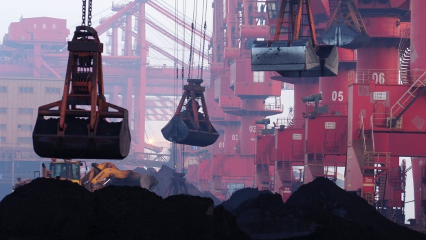  heavy machines move imported iron ore at the dock in Rizhao in eastern China's Shandong province. 
