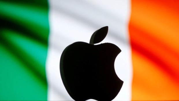 A 3D printed Apple logo is seen in front of a displayed Irish flag in this illustration 