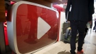 A man walks past a YouTube logo at the YouTube Space LA in Playa Del Rey, Los Angeles