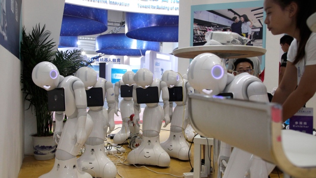 Robots powered down are lined up at the World Robot Conference held in Beijing, China
