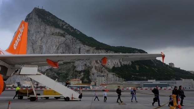 Passengers disembark from an EasyJet flight after arriving at Gibraltar airport