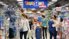 In this Friday, Nov. 25, 2016, file photo, shoppers shop in a Toys R Us store on Black Friday