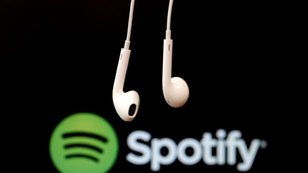 FILE PHOTO: Headphones are seen in front of a logo of online music streaming service Spotify in this illustration picture