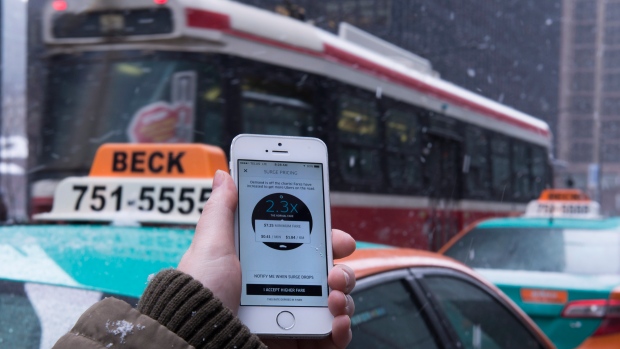 A screenshot of the Uber ride-sharing app showing surge pricing in effect is shown in Toronto