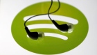 Earphones are seen on a tablet screen with a Spotify logo on it, in Zenica, Bosnia and Herzegovina