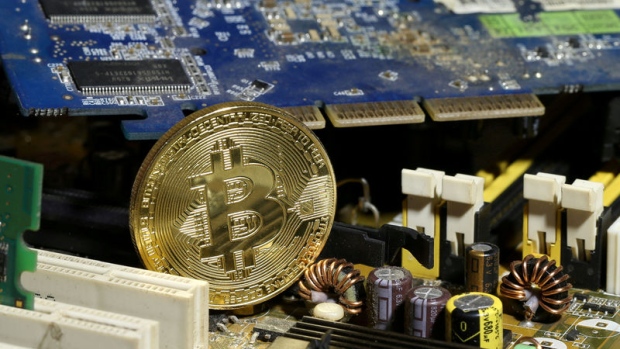 A copy of bitcoin standing on PC motherboard is seen in this illustration picture, October 26, 2017.